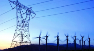 Power lines stretching above a group of windmills
