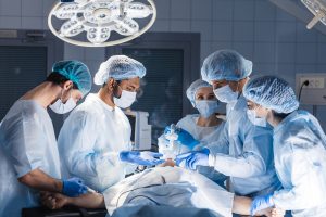 surgeons around a patient in an operating theatre