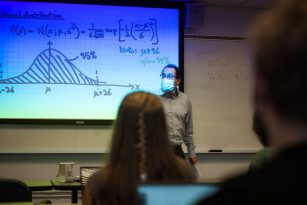 Youssef Marzouk teaches in front of a classroom