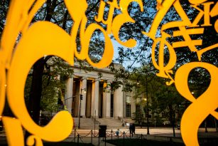 A photo of the main MIT building and the Alchemist sculpture