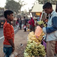 Two children in India talking at a market